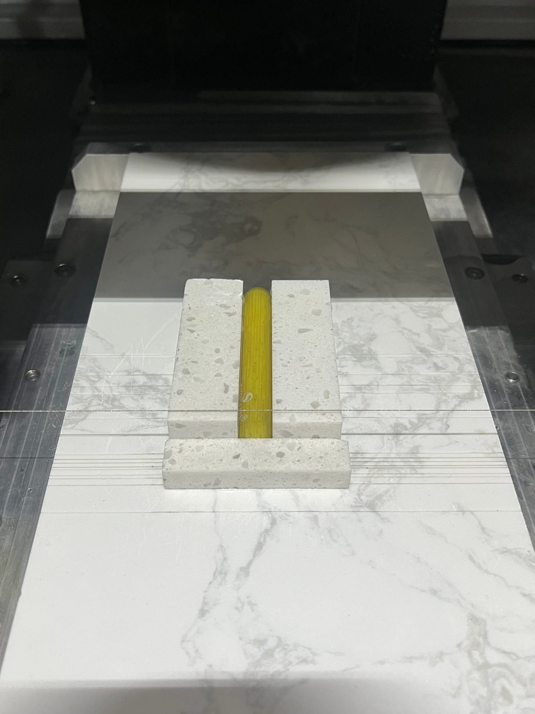 Glass tube being cut by endless diamond wire